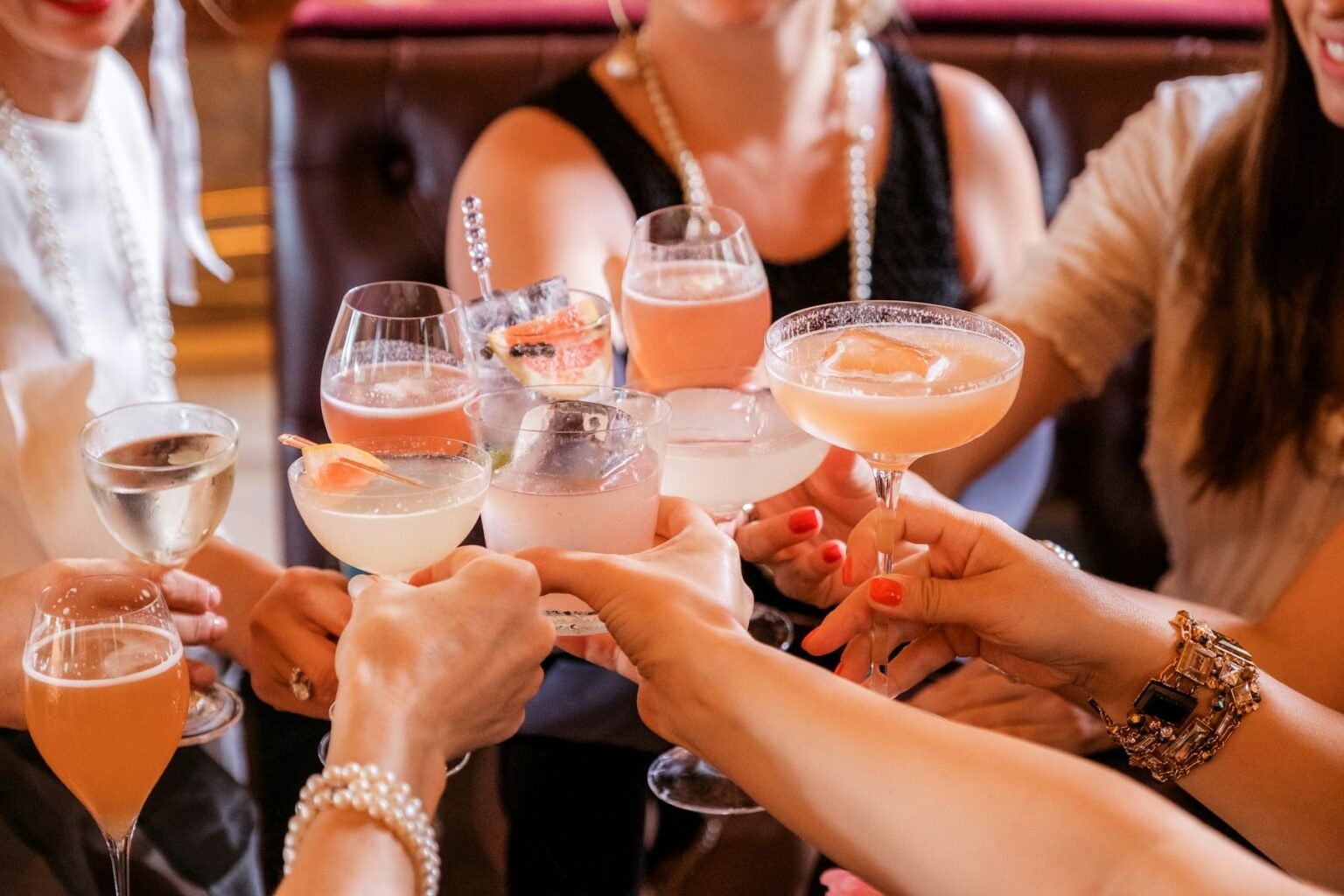 A group of friends raising cocktail glasses
